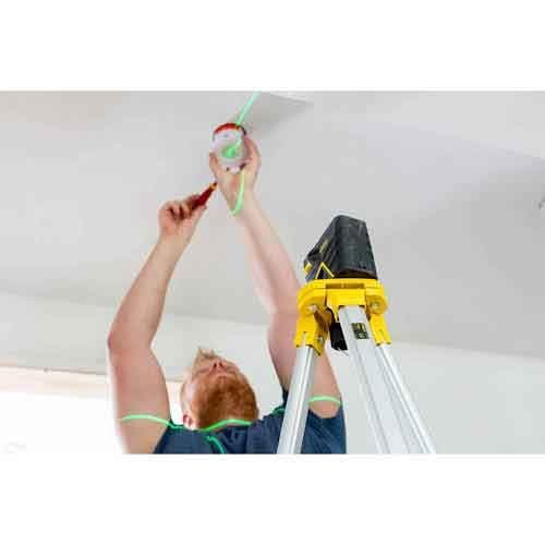 Image d'un homme sur escabeau utilisant le niveau laser vert croix + 2 points à batterie - STANLEY Fatmax